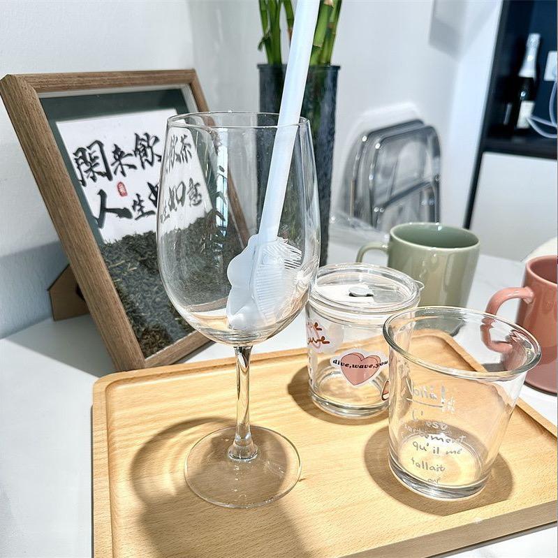 A  Bottle Cup Cleaning Brush with Long Handle is Kept in a Glass Cup