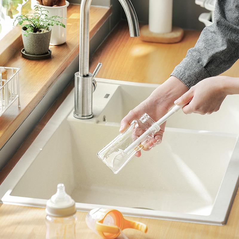 A Person is Cleaning a Bottle Using  Bottle Cup Cleaning Brush with Long Handle.