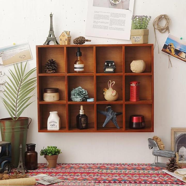 Wooden Wall Hanging Display Rack With Decors and Pots Are Diaplayed On it.