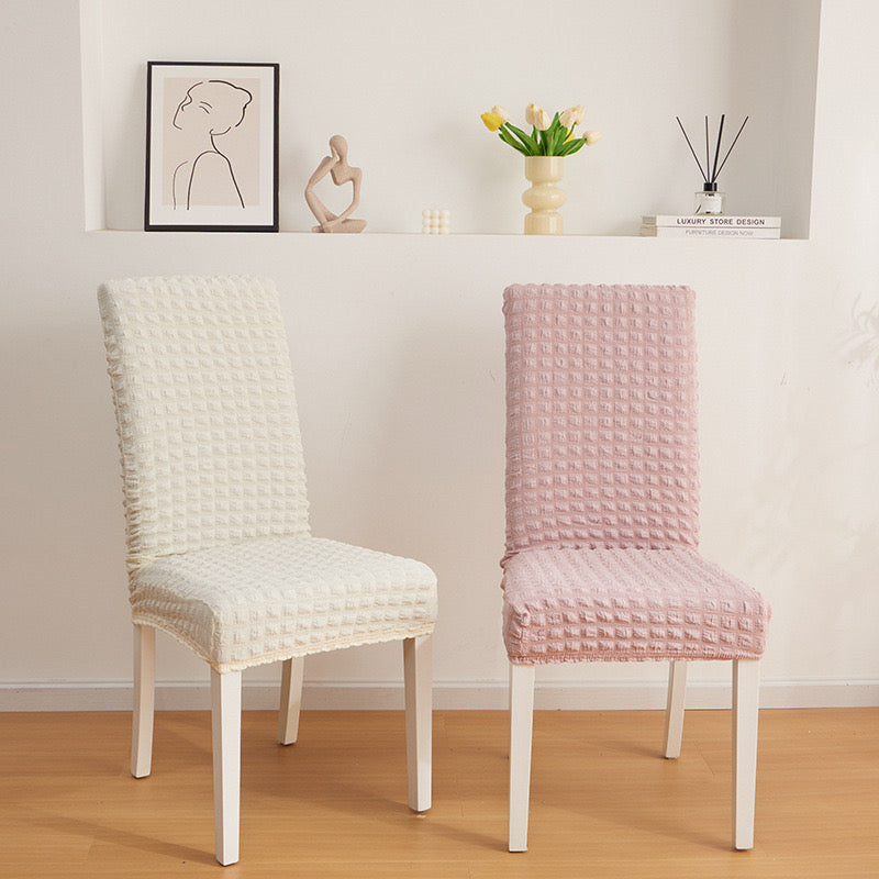 Two Chairs Are Covered With Bubble Stuff Stretchable Chair Cover.