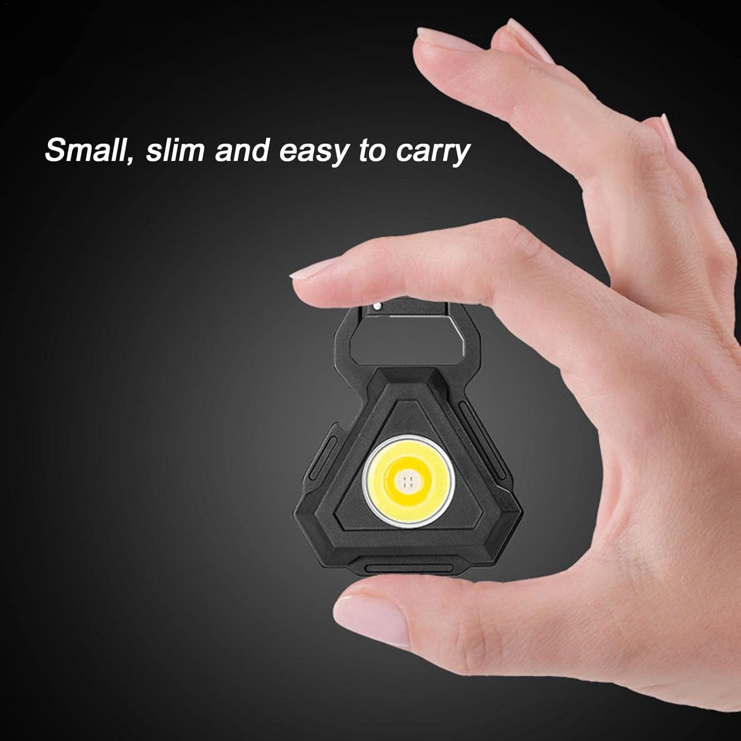 A Person is Holding COB rechargeable keychain pocket light.