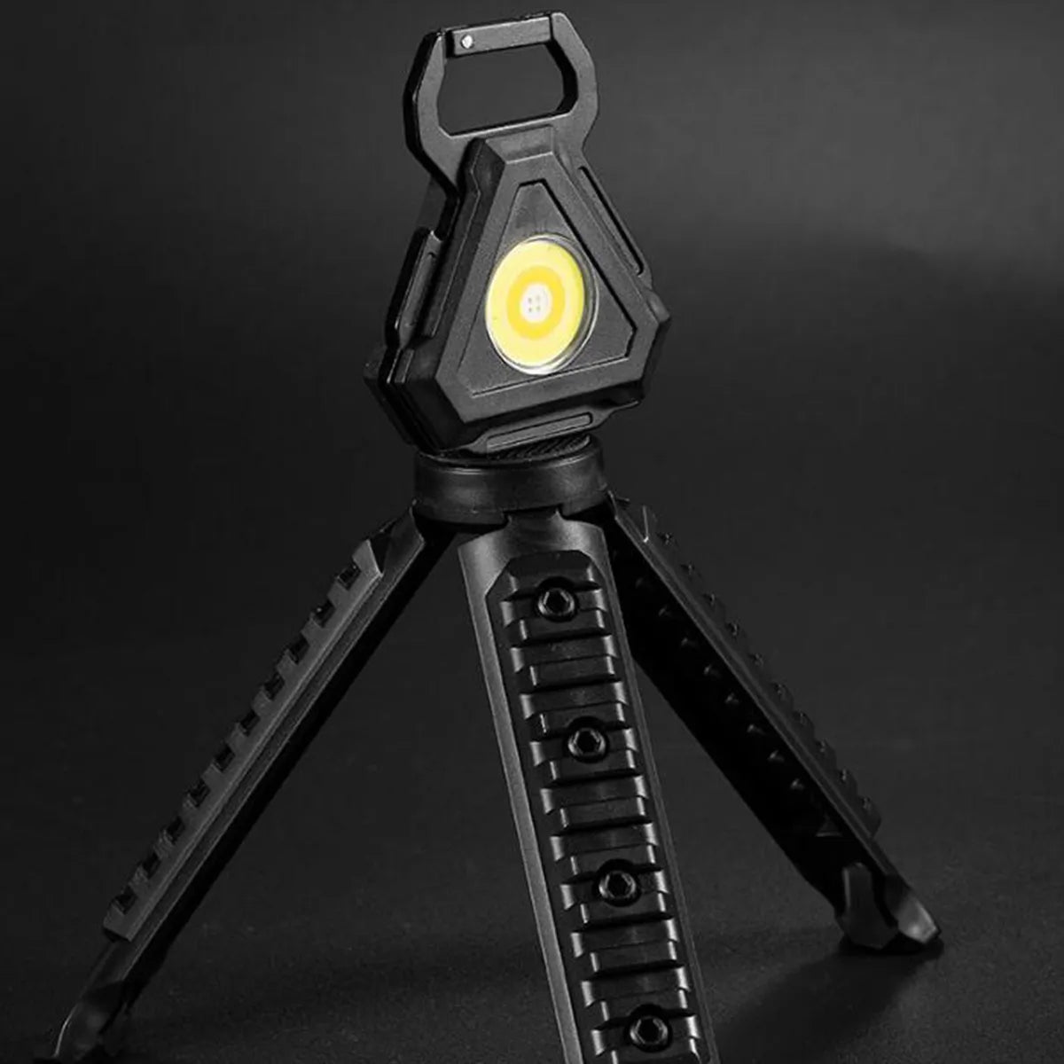  A COB rechargeable keychain pocket light with its stand.