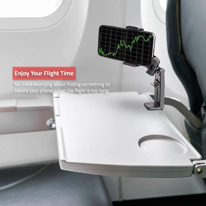 A Mobile Phone is Placed On Aircraft Dining Using Universal Mobile Phone Mount Holder.