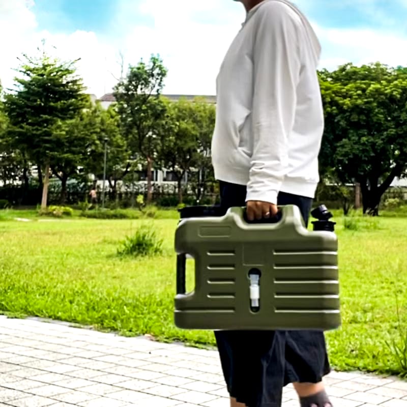 A Person is Holding Camping Water Storage Container.