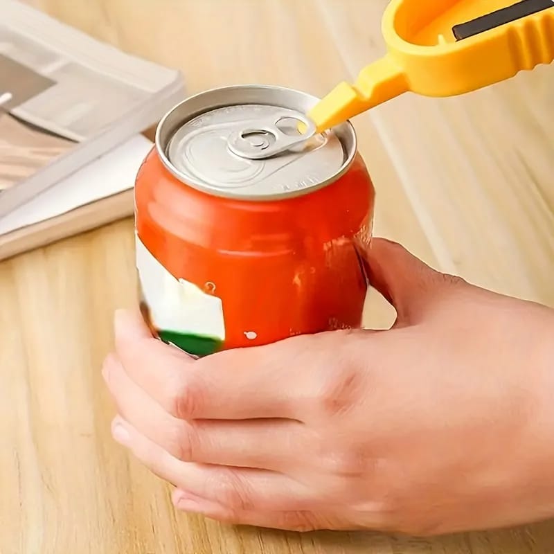 A Person is Opening The Lid Of a Can Using Bottle Can Opener.