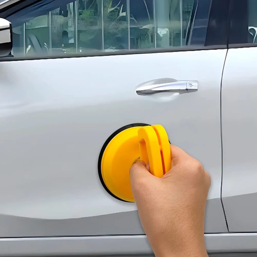 A Person is Repairing Car Door Using Car Dent Puller Removal Tool.