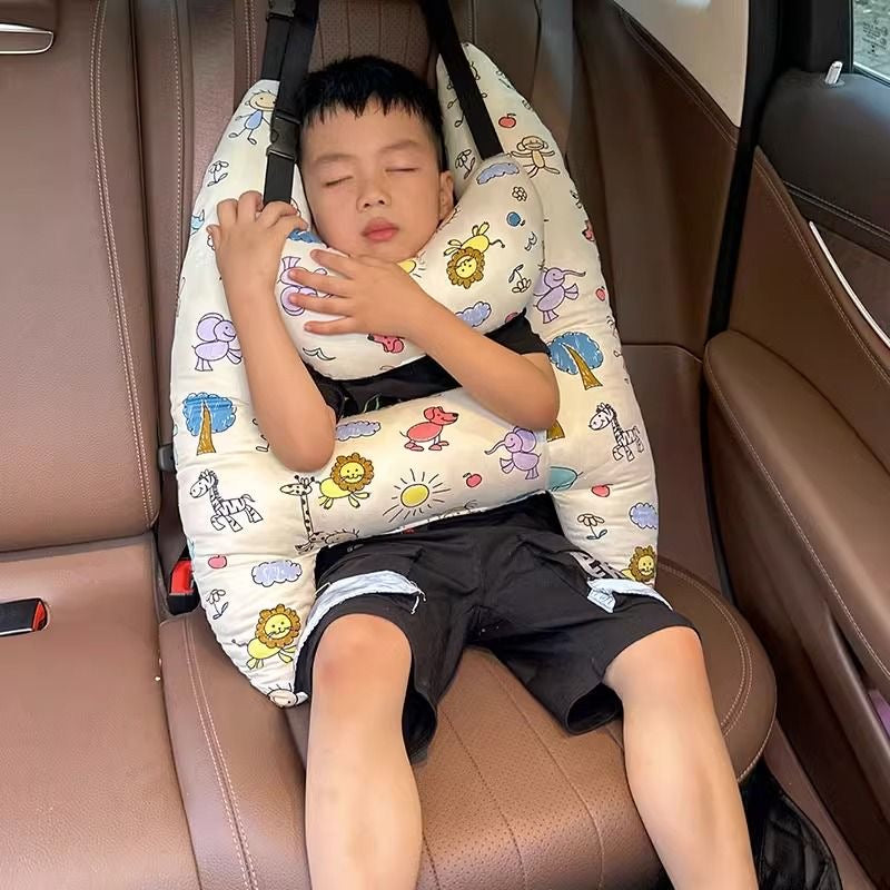 A child sleeping in a car with the assistance of a Car Seat Travel Pillow