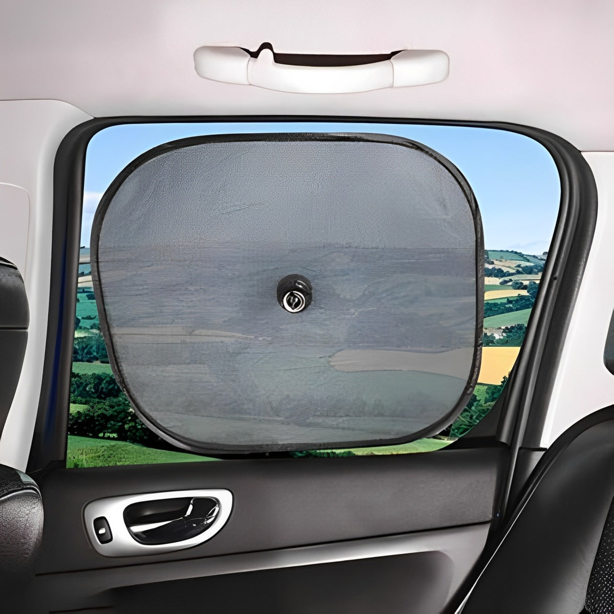 A Car Sun Shade is Fixed on a Car Window.