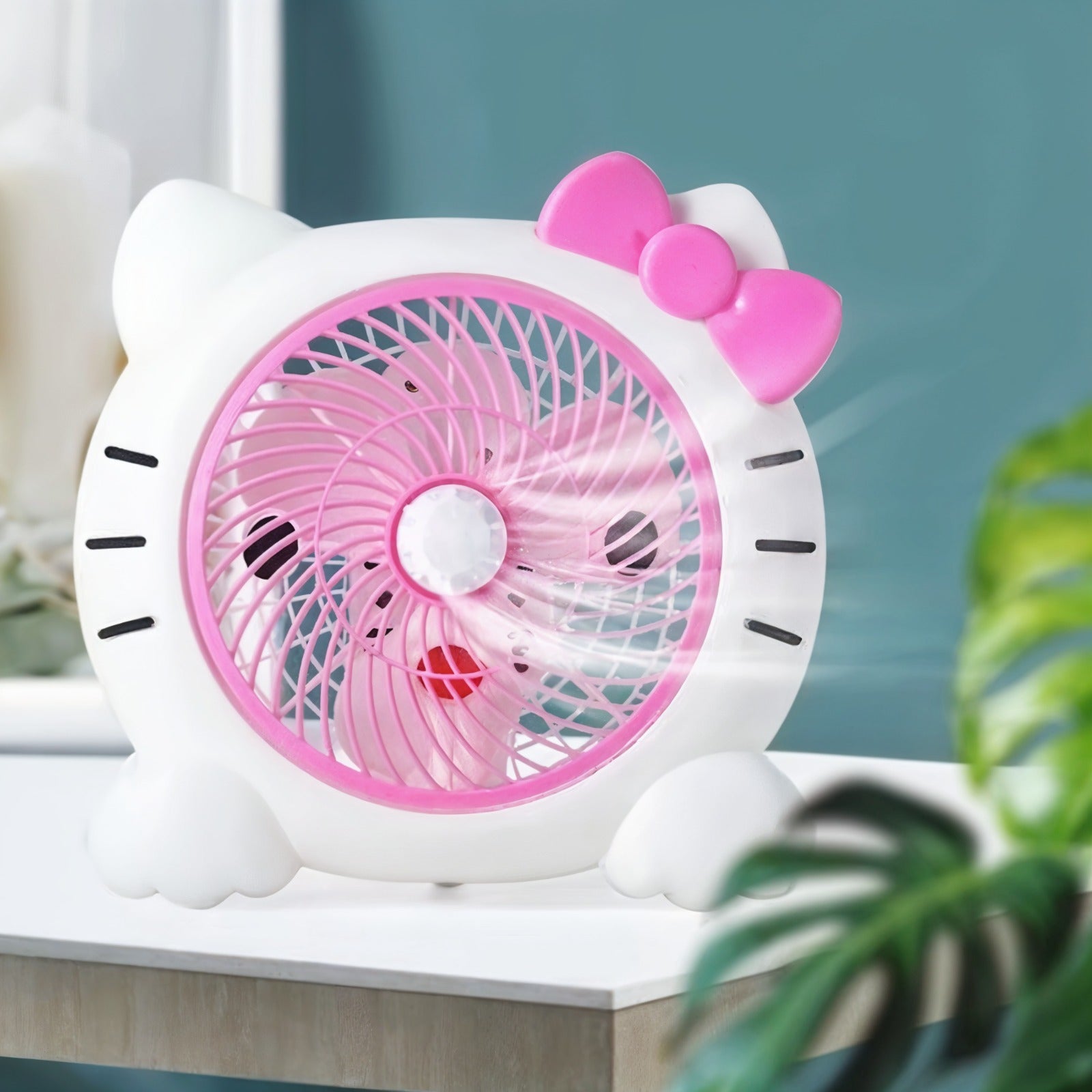  Cartoon Mini Desk Personal Fan is Kept on a Table.
