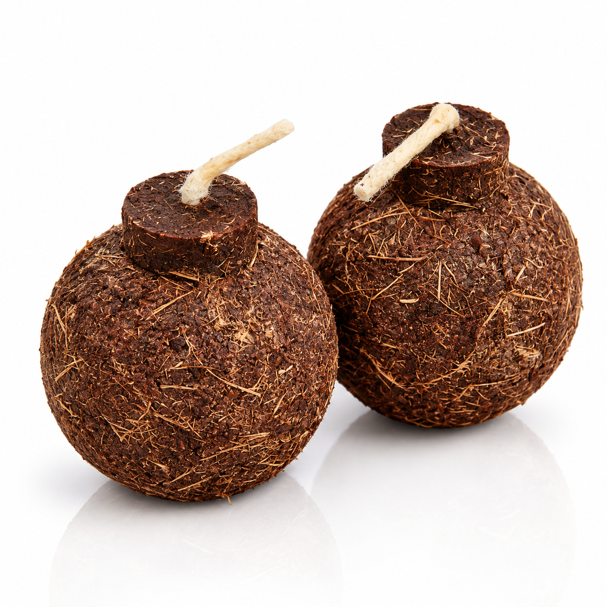 Two Coco Boom Coconut Shell Fire Starter with short white wicks, photographed on a clean white background.