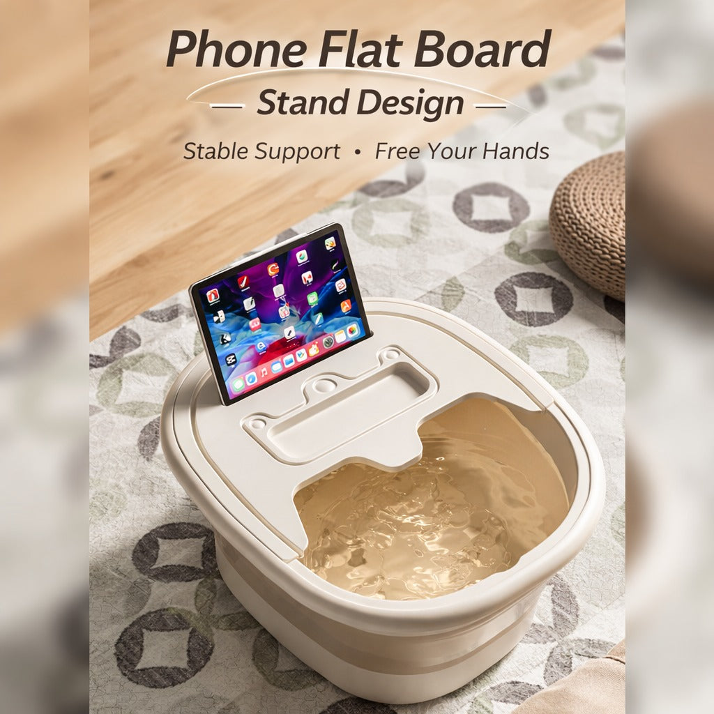 Collapsible foot spa basin filled with warm water, featuring a built-in phone and tablet stand on the lid for hands-free use, placed on a patterned floor mat