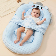 A Baby is lying down on the Comfortable Baby Nest Bed.