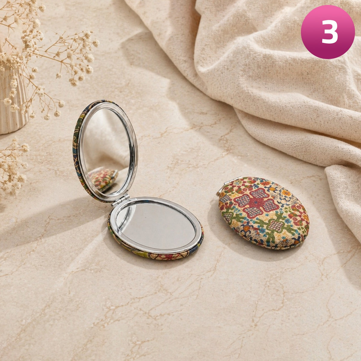 Compact mirror with floral design on a textured surface
