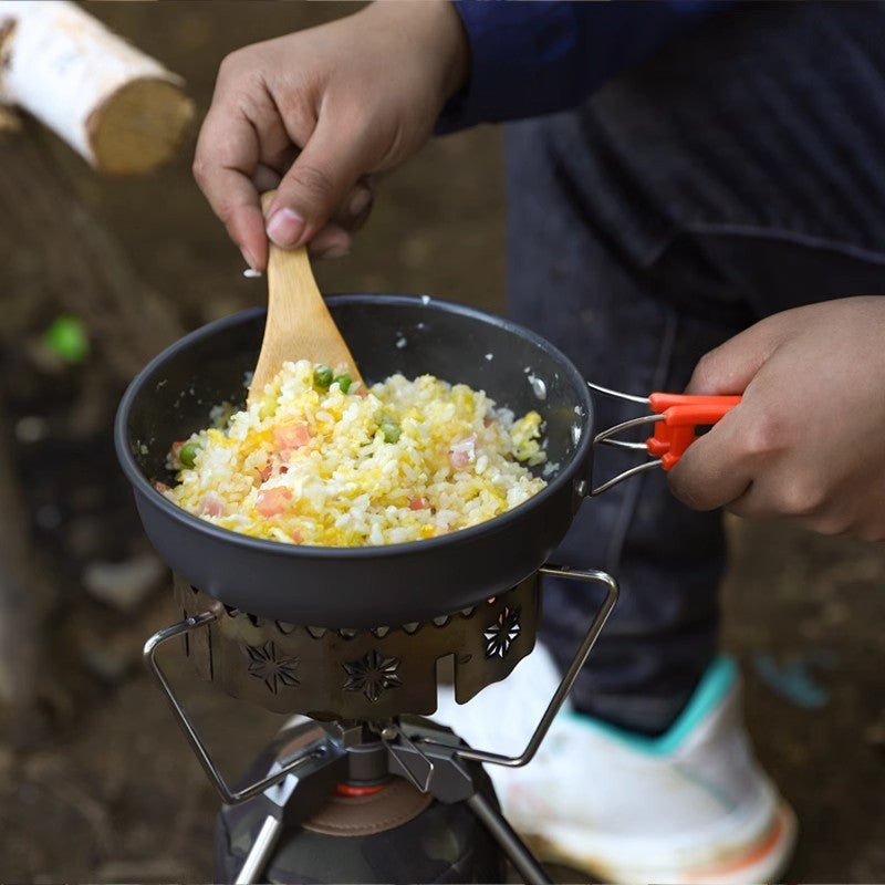 A Person is Cooking in a Camping Outdoor Cookware Set.