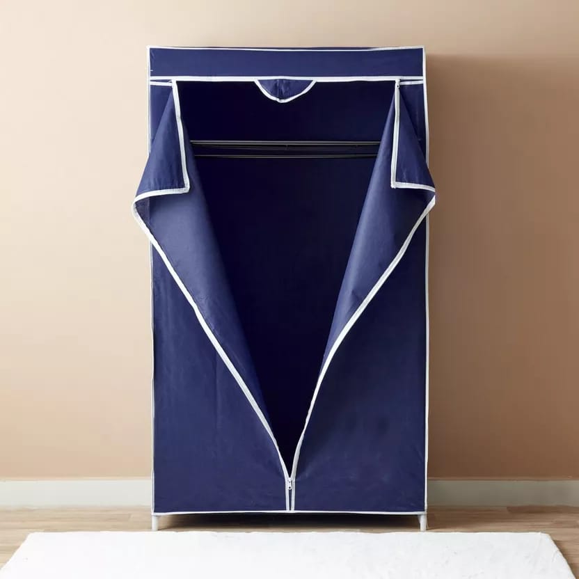 Portable Closet Shelf Storage with Dress Hanging Rack placed in the room