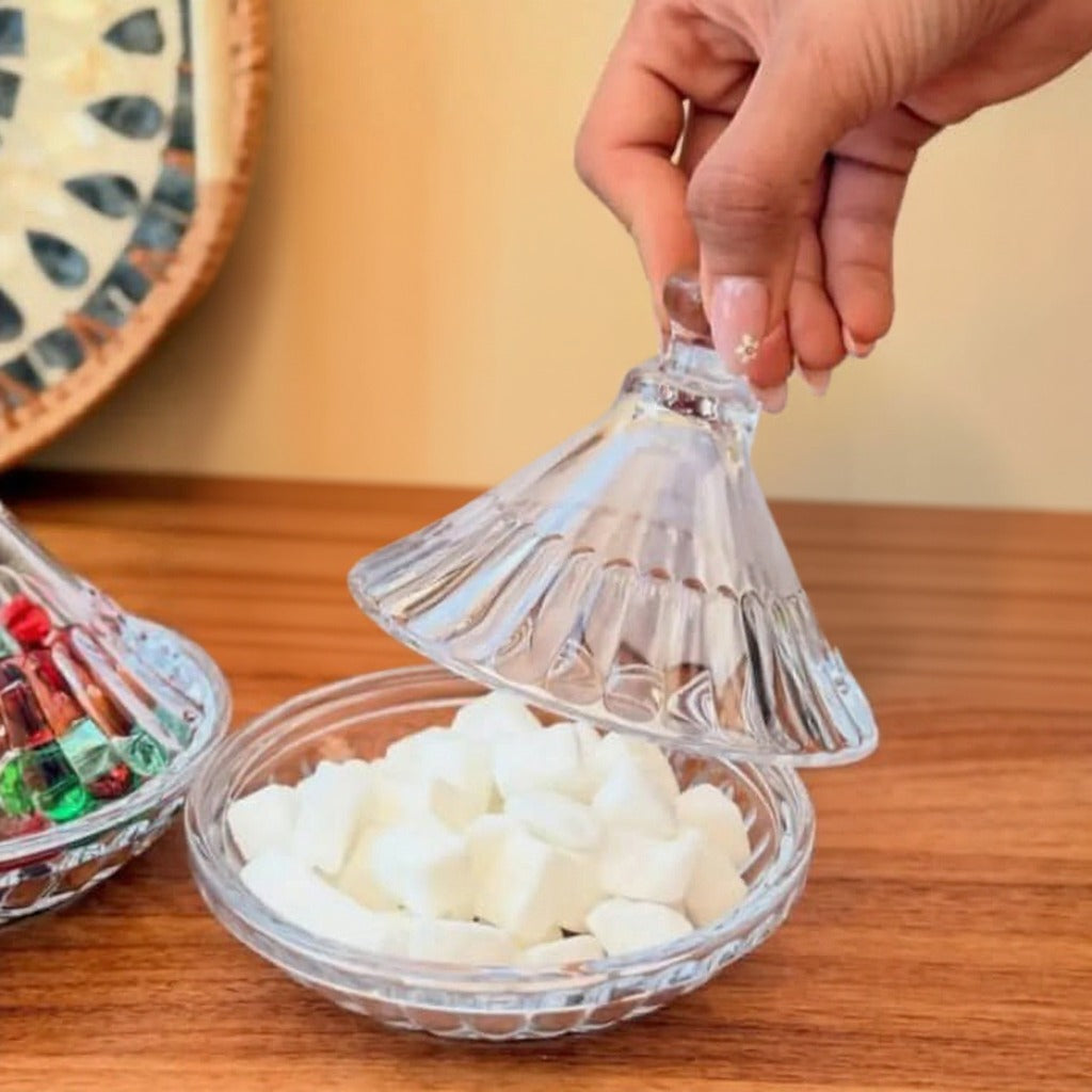A Person is Holding Lid Of Crystal Clear Glass Candy Jar.