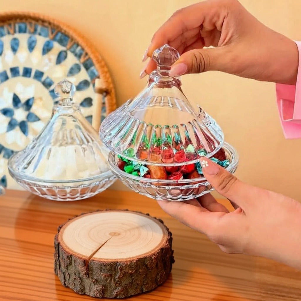 Someone is Holding Crystal Clear Glass Candy Jar.
