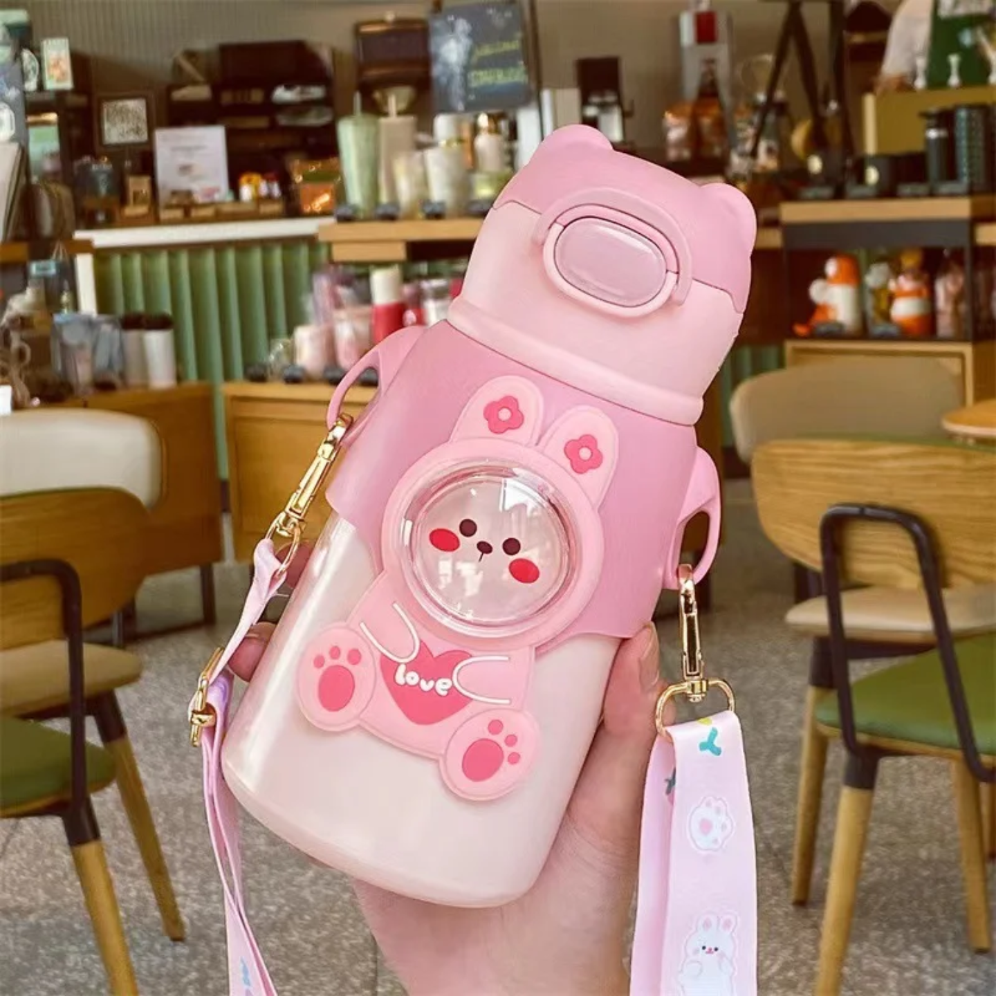 A Person is Holding Cute Cartoon Bear Water Bottle for Kids.