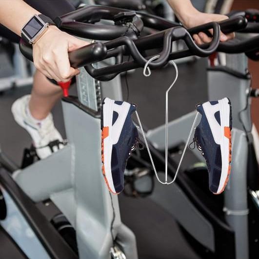 A Person is Hanged Shoe Drying Hanger Organizer On His Cycle.