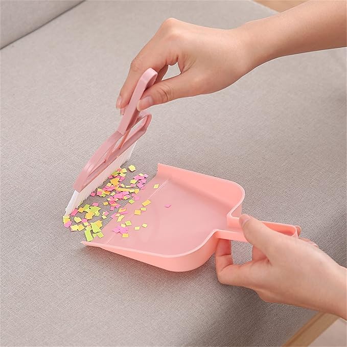 A Person is Cleaning Sofa Using  Mini Dustpan Broom Set.