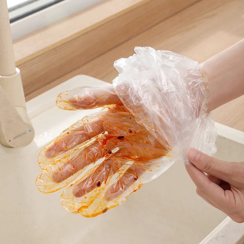 A Person is Removing Disposable Anti- Slip Wear Long Sleeve Gloves.