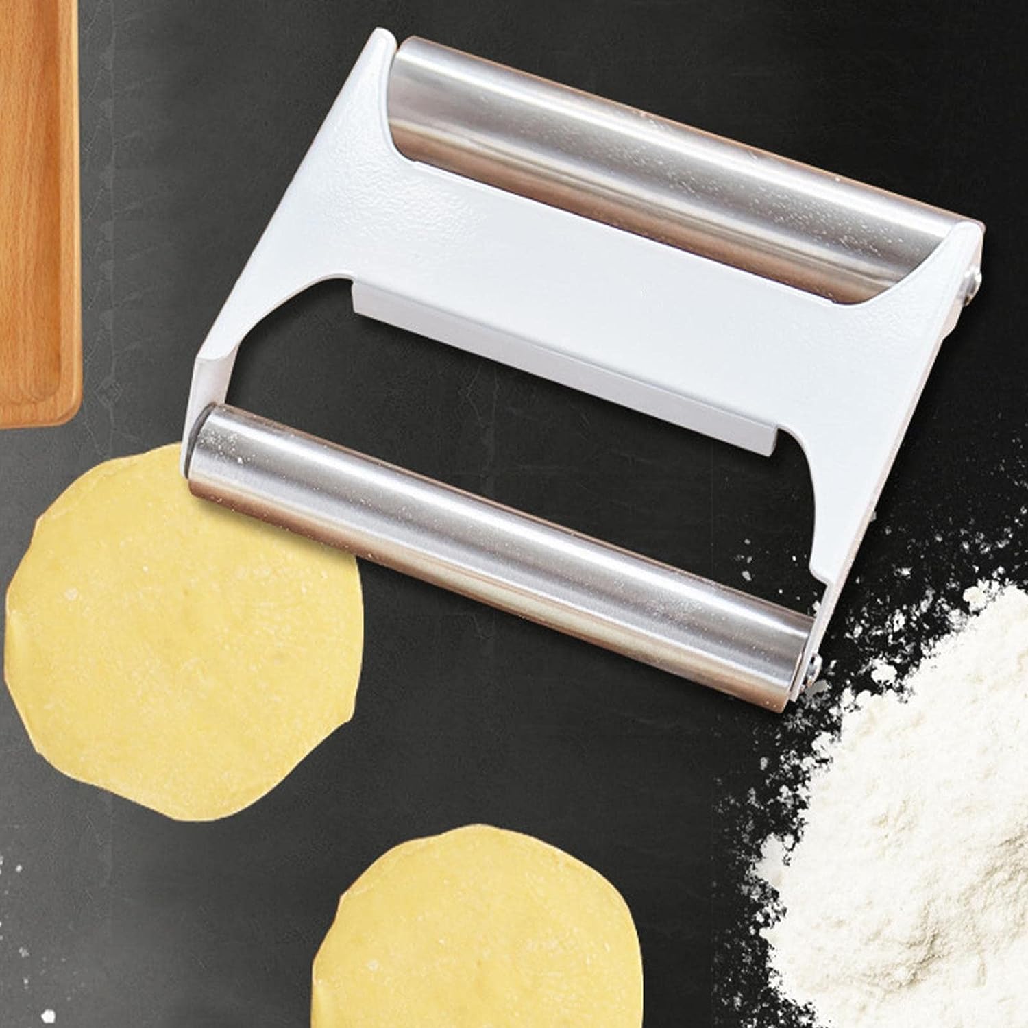 Double-Sided Stainless Steel Dough Roller for Baking placed on the table next to some Dumplings