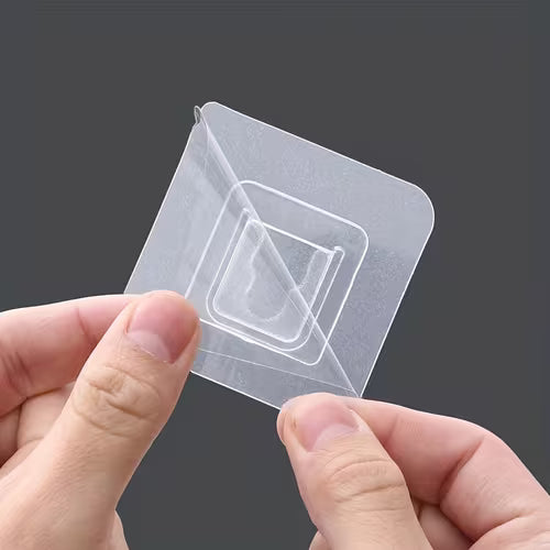 A hand is peeling Double Sided Self Adhesive Wall Hooks.