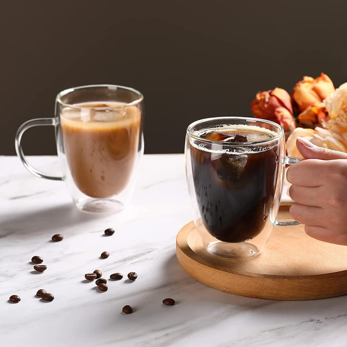 A Person is Holding Double Wall Glass Coffee Mug with Coffee.