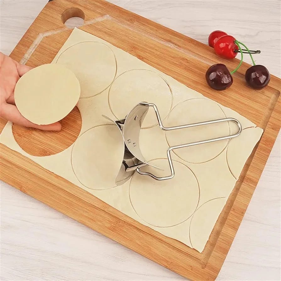 A Person is Cutting Dough Using Dumpling Wrapper Maker.