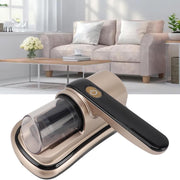 Wireless Dust Mite Removal Vacuum Cleaner with a metallic champagne-gold body, black handle, and clear dust container, shown in front of a blurred living room background with a sofa and coffee table.
