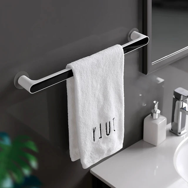 A towel is organized on the Towel Organizer Hanger in black color