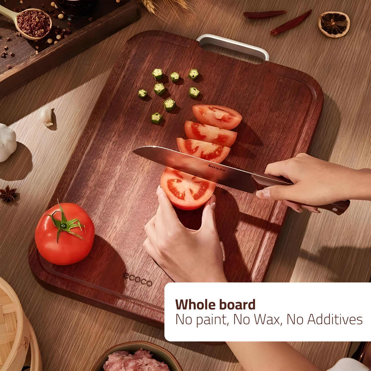 Someone Cutting Vegetables On the Ecoco Ebony Wooden Chopping Board.