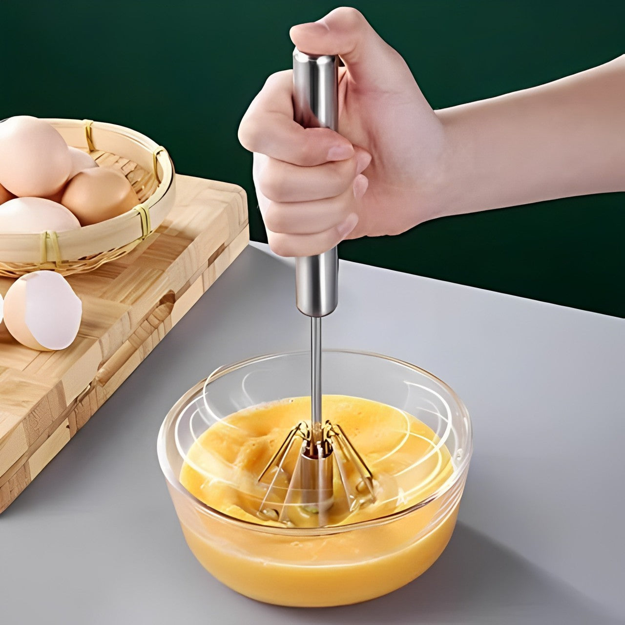 A Person is Beating Egg Using Egg Beater.