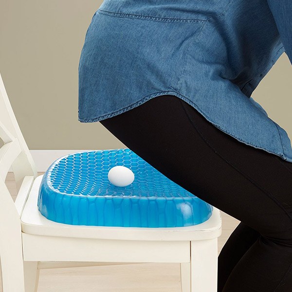 Someone sitting with the assistance of an Egg Sitter Gel Chair Cushion