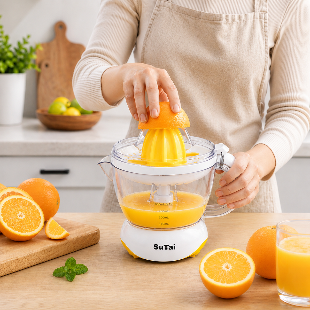 A Woman is Making Citrus Juice using Electric Citrus Juicer.