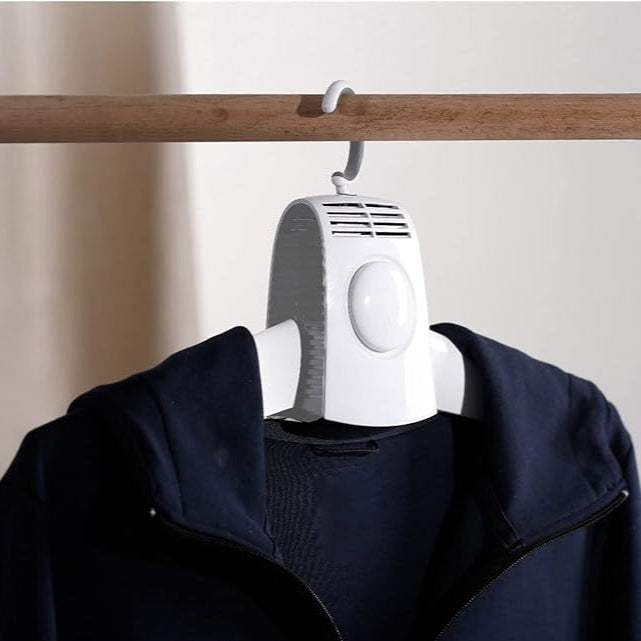 A Cloth is Hanged On the Electric Cloth / Shoes Drying Hanger.