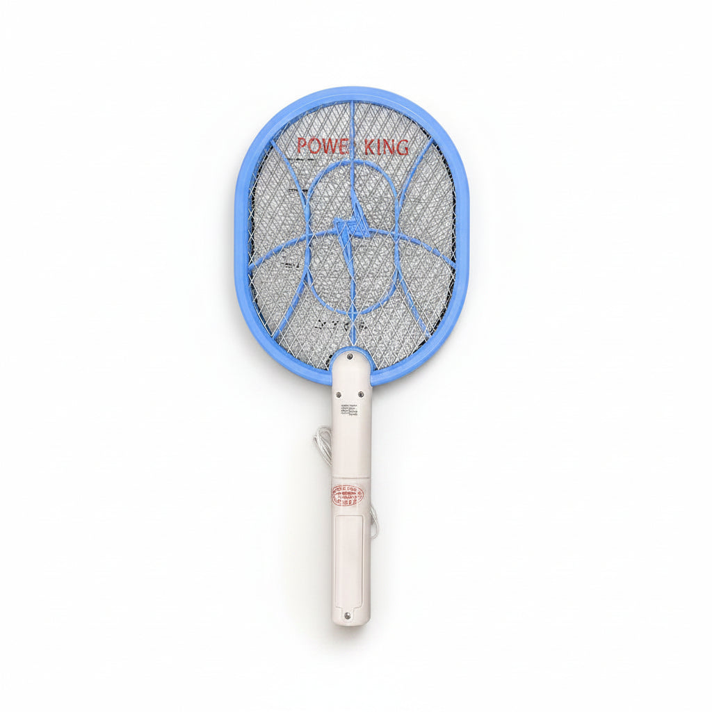 Electric fly swatter with blue frame and white handle on a light surface with plants and stationery items.