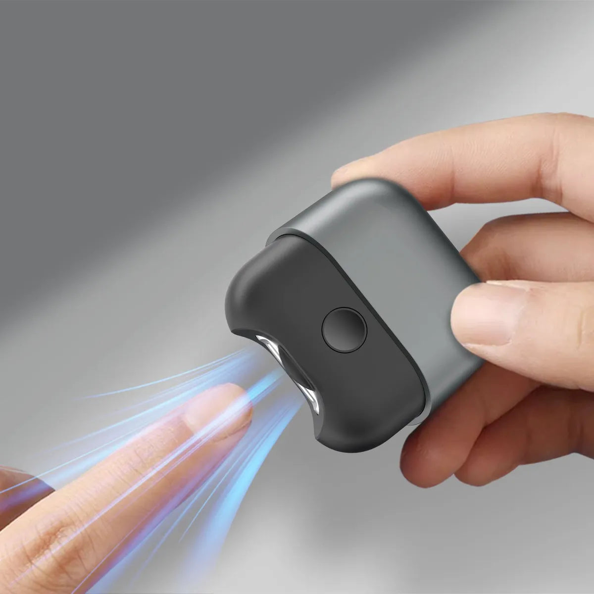 A person using an Electric Polishing Nail Clipper, holding the compact device while trimming their fingernail with precision.