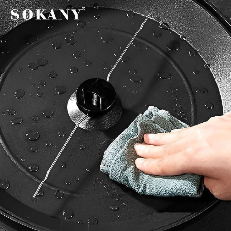 A Person is Cleaning Non-Stick Plate Of Electric Popcorn Maker.