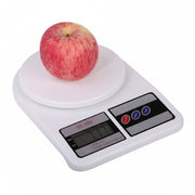 Digital kitchen scale with an apple on a white background
