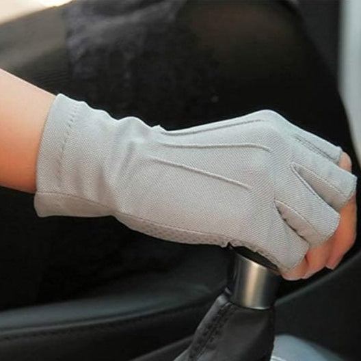 A Person is Wearing Fingerless Gloves While Driving.