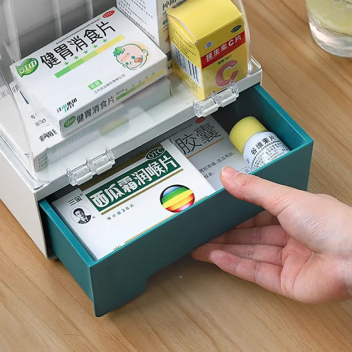 A Person is Opening the Drawer Of First Aid Kit Medicine Storage Box.
