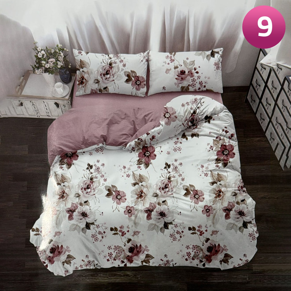 Floral bedding set on a bed in a bedroom setting with a pink number 9 in the corner.