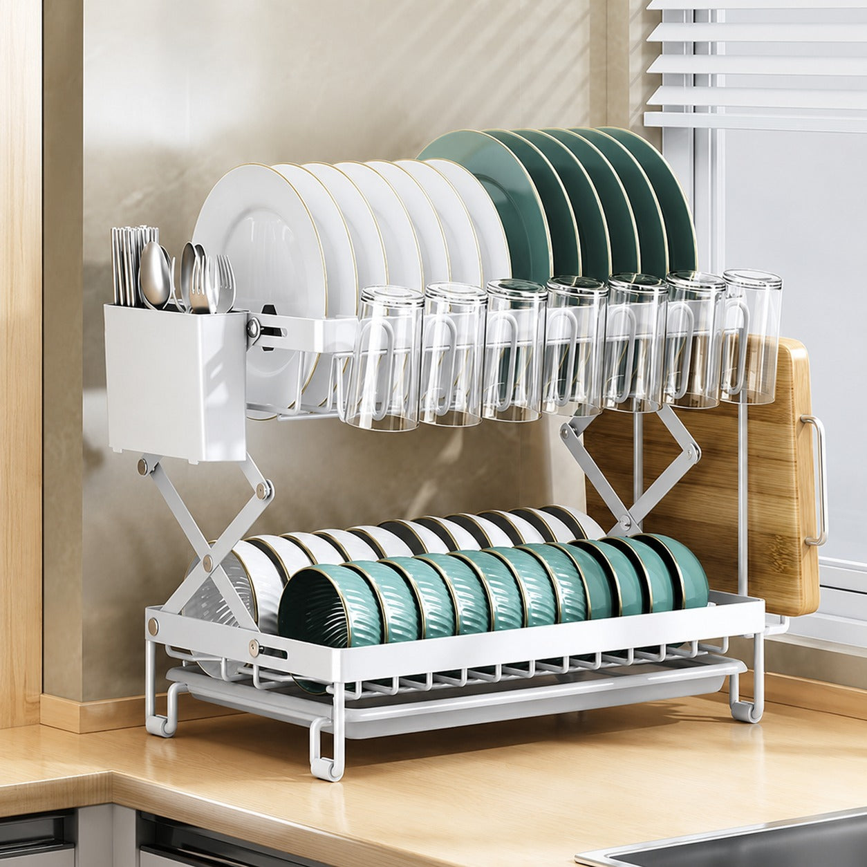 Dish drying rack with plates, glasses, and cutlery on a kitchen counter.