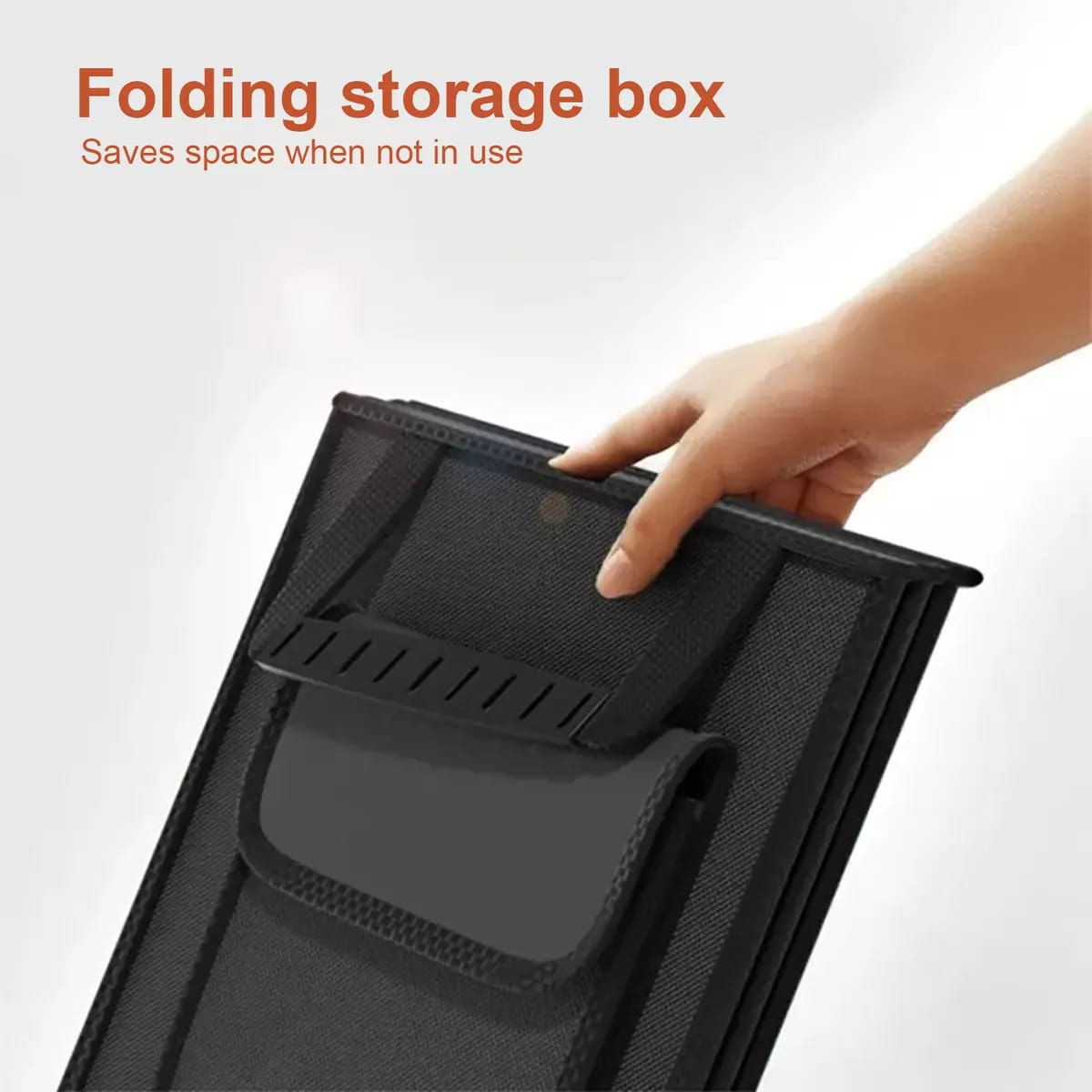 A Person is Holding Folded Form Of Foldable Car Storage Box.