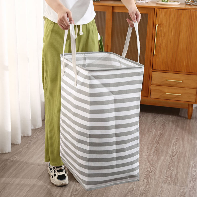 A Women Holds Foldable Cloth Storage Laundry Bin.