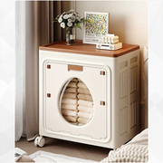 A Foldable Cloth Storage Organizer Box is kept on the side of modern room neatly filled with folded clothes.