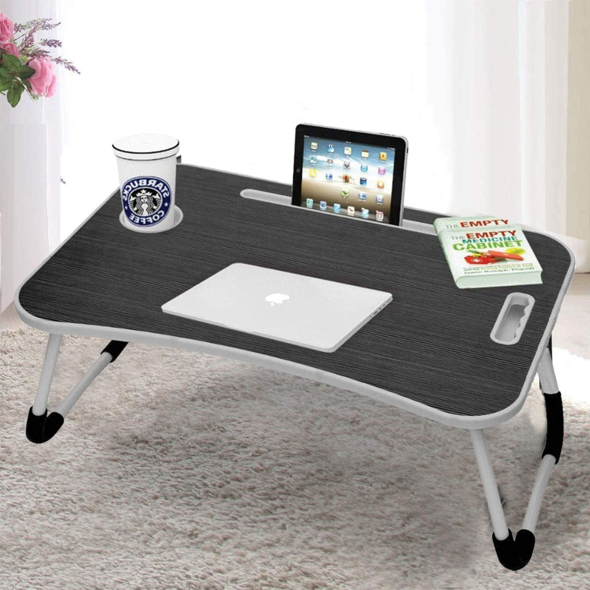 Portable laptop desk with a laptop, tablet, and coffee cup on a white surface.