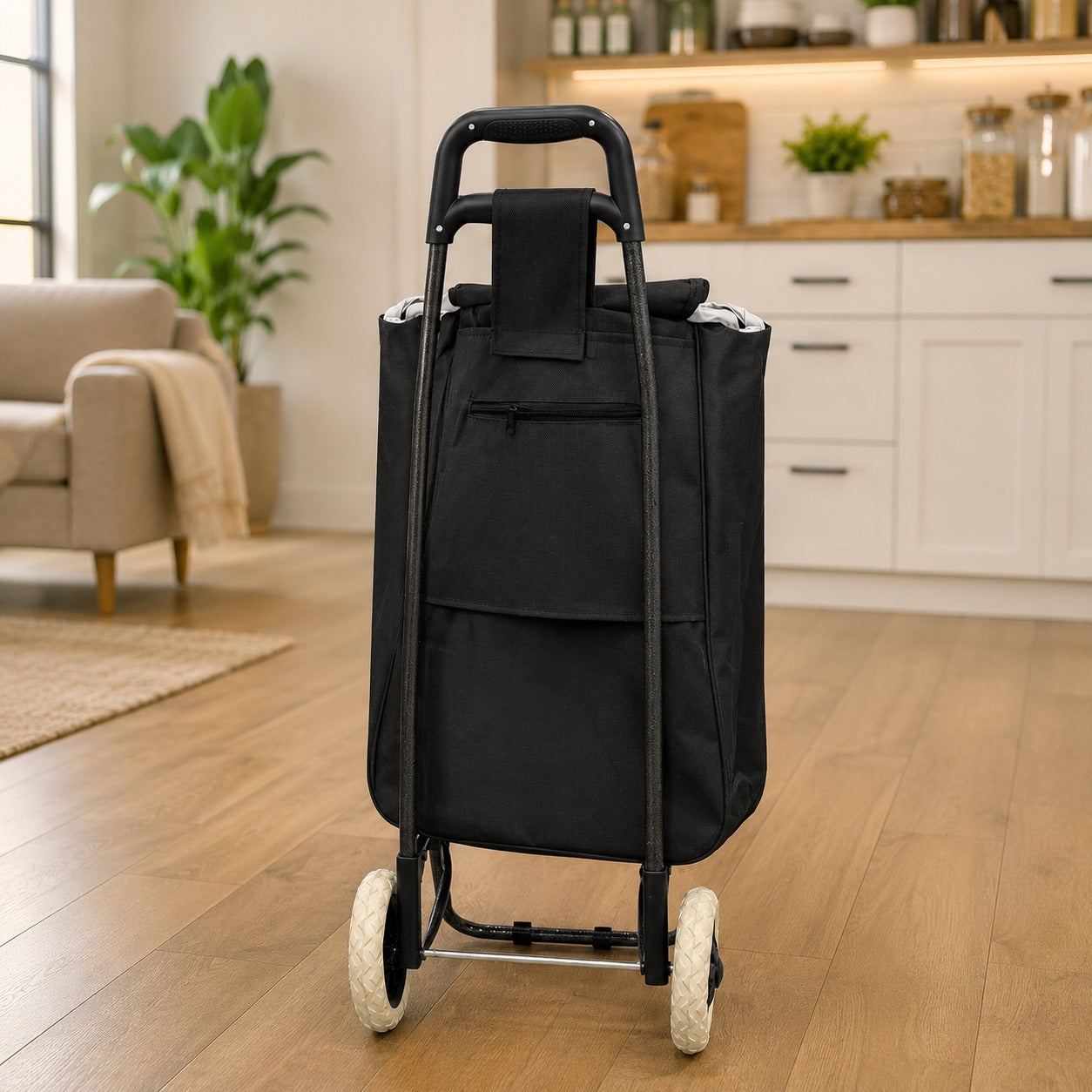 A Foldable Shopping Bag Trolley Cart with a handle and two wheels, shown standing upright in a bright, modern living room and kitchen interior.