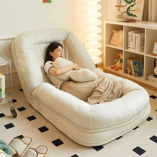 A Women is Sleeping on the Folding Lazy Sofa.